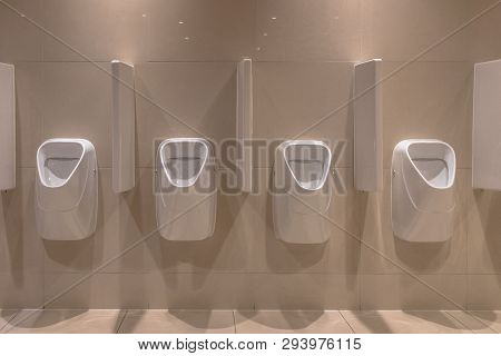 Row Of Modern Urinals In New Bathroom Of Theater