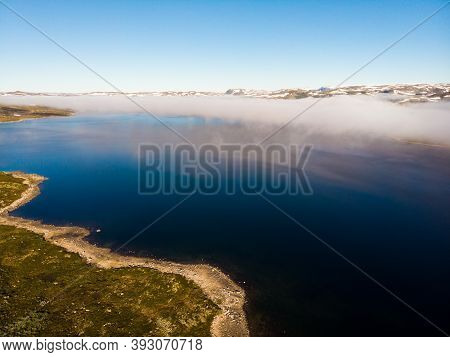 Aerial View. Hardangervidda Mountain Plateau, Norway Landscape. Morning Time, Clouds Over Lake Water