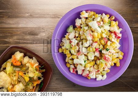 Crab Salad On Purple Plate With Vegetaible Salad Top View. Crabs Salad On Brown Wooden Background