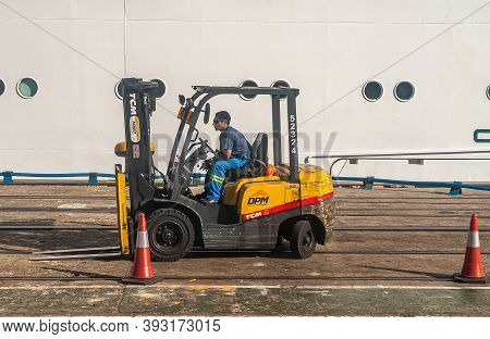 Montevideo, Uruguay- December 18, 2008: Closeup Of Male Worker On Black-yellow Dpm Forklift In Port.