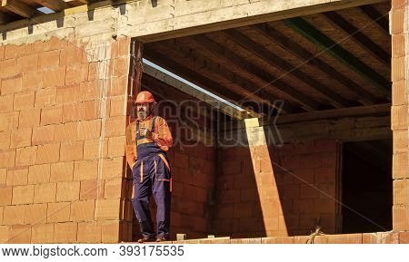 Well Done. Repairman Tired Builder Relaxing At Construction Site. Builder Smoking Cigarette. Break A