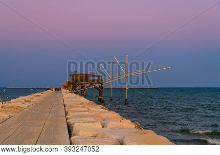 Traditional Fishing Stations Houses With Fishnet In Water Of Adriatic Sea At Pier Diga Sottomarina, 