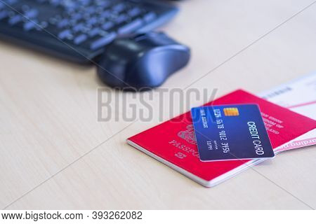 Close-up Of The Blue Credit Card Is Placed On Passport And Plane Ticket. Prepare For Travel. Credit 