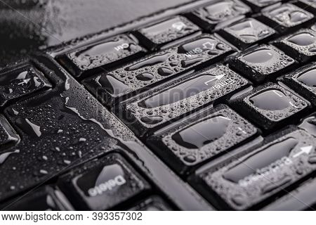 Water Drops On The Computer Keyboard. Water Flooded Computer Keys.