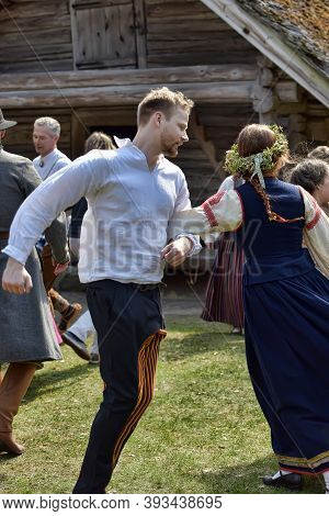 Latvian Culture Tradition. Midsummer In Latvia.. Folk Dance Group In Latvian Traditional Costume.