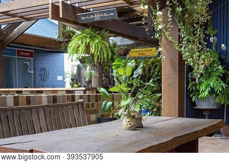 Proserpine, Queensland, Australia - October 2020: Pot Plants And Hanging Vines Surrounding An Outdoo