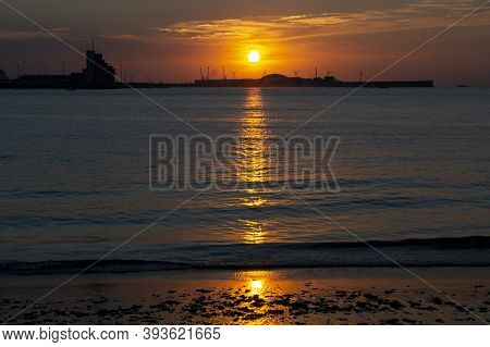 Sunset With Orange Color In The Sky At Getxo-guecho Beach. Spanish Municipality Located On The Coast