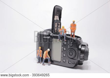 A Mini People Worker Holding Tool At Speedlight