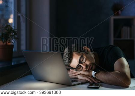 Young Overworked Distressed Businessman Freelancer Fell Asleep At Workplace While Working Remotely O
