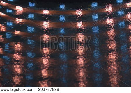 Reflection Of Red And Blue Lights In The Water. Light Pattern As Background. Stock Photo