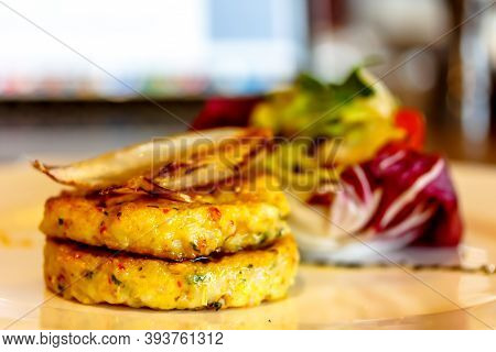 Hashbrown Potato Patties Are Served With Salad On A Plate. Largly
