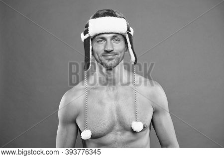 Male In Earflap Winter Hat. Happy New Year. Xmas Party For Adult. Handsome Santa Feel Warm And Hot. 