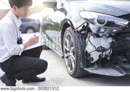 Asian Saleman Inspector Checking Writing On Clipboard Change Wheels In Garage Of Dealership Mechanic