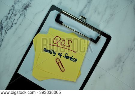 Qos - Quality Of Service Write On Sticky Note Isolated On Wooden Table. Business Concept