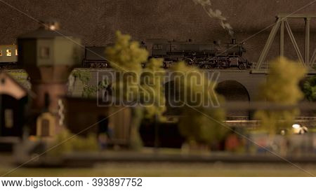 Model Of Lokomotive Train On The Bridge. Miniature Toy Plastic Railway Station.