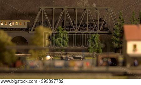 Model Of Retro Lokomotive On The Bridge. Miniature Train With Smoke.