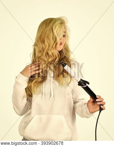 Is It Me You Are Looking For Girl Care About Her Hairstyle. Woman Curling Hair With Straightener. Wo
