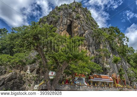 Thailand, Phetchaburi 19.07.2019 View Of Wat Tham Khao Yoi Cave, Buddhist Temple With Green Tree And