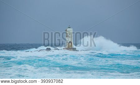 Waves Crashing Against The Mangiabarche Lighthouse; Scoglio Mangiabarche, Calsetta, South Sardinia