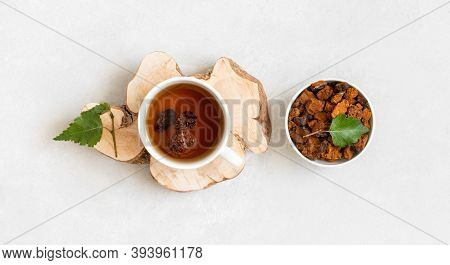 Chaga Tea And Pieces Of Chaga Mushroom On A White Background. Organic Infusion With Pieces Of Chaga.