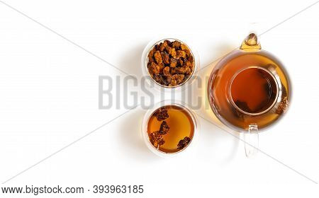 Chaga Tea And Chaga Mushroom Pieces In Glass Bowls And Teapot Isolated On A White Background. Copy S