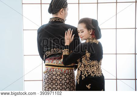 Portrait Happy Men And Women Wearing Javanese Traditional Clothes.