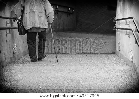 Rare View Of Senior Coming Down Stairs. Black And White