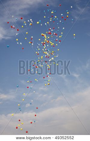 Varicoloured balloons fly on air on a background sky