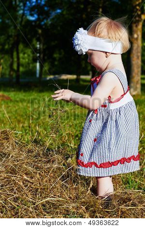 Little Girl Plays With  A Straw