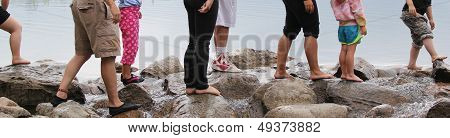 Crowd's Feet walking across waterfall