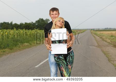 Funny Couple  Shows Blank Piece Of Paper