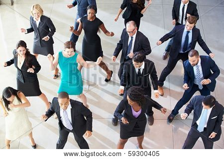 Overhead View Of Businesspeople Dancing In Office Lobby