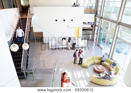 Reception Area Of Modern Office Building With People