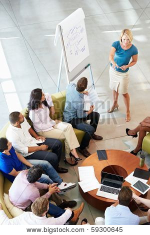Businesswoman Making Presentation To Office Colleagues