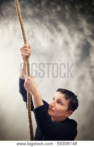 Woman Climbing Up With Rope