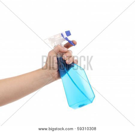 Hand holding blue plastic spray bottle
