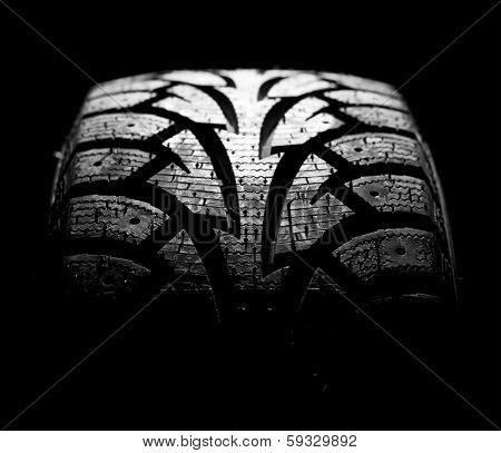  winter car tyre on a black background