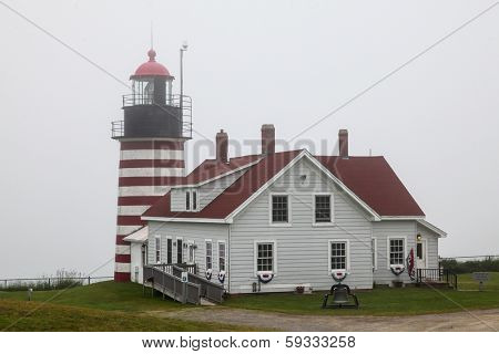 LUBEC-JULY 10: West Quody lighthouse in fogy day in Maine, USA on July 10, 2013.