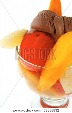 fresh raw  tropical fruits with chocolate ice cream in big glass isolated on white background