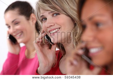 Young women talking on their mobile phones