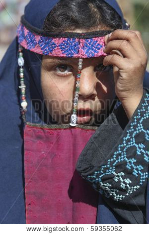 DAHAB, EGYPT - JANUARY 24, 2011: Egyptian girl posing in a burqa with traditional ornaments.