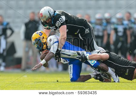 INNSBRUCK,  AUSTRIA - MARCH 23 DL Reinhard Pardeller (#98 Raiders), tackles QB Alex Good (#7 Giants) during the AFL football game on March 23, 2013 in Innsbruck, Austria.
