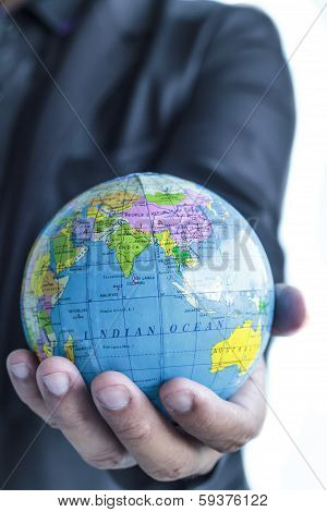 man holds Earth in a hand
