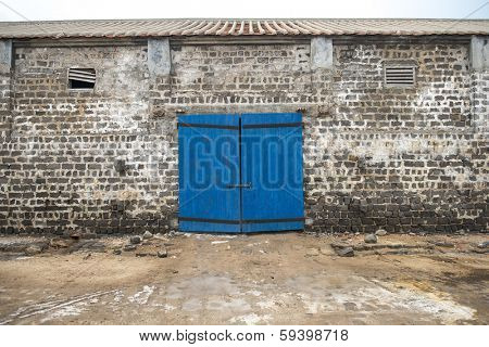 wall of ancient wooden barn with door