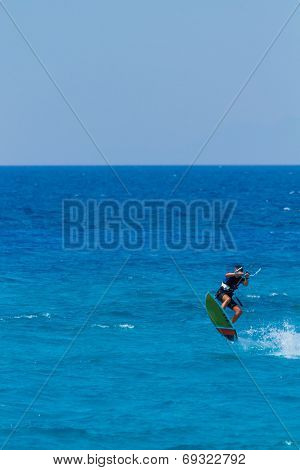 young kiter in the surrounding of turquoise sea kiting in Lefkas Greece