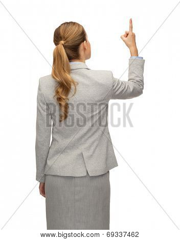 business, education, people and office concept - businesswoman or teacher in suit raised finger from back