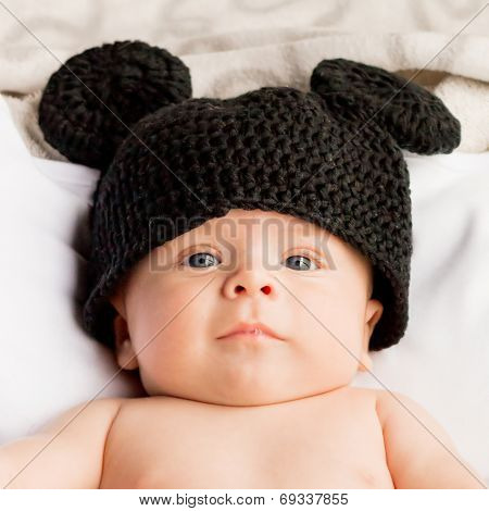 Two month baby with a black wool hat