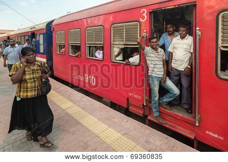 COLOMBO, SRI LANKA - FEBRUARY 22, 2014: Commuters in train at Colombo station. Trains are very cheap and poorly maintained but it's the best option to witness a bit of everyday local life.