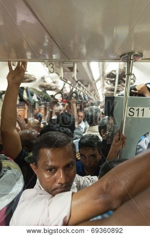 HIKKADUWA, SRI LANKA - FEBRUARY 22, 2014: Crowded commuter train to Colombo. Trains are very cheap and poorly maintained but it's the best option to witness a bit of everyday local life.