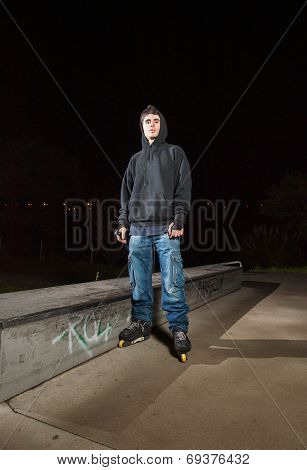 Rollerskater In A Skateboard Park At Night